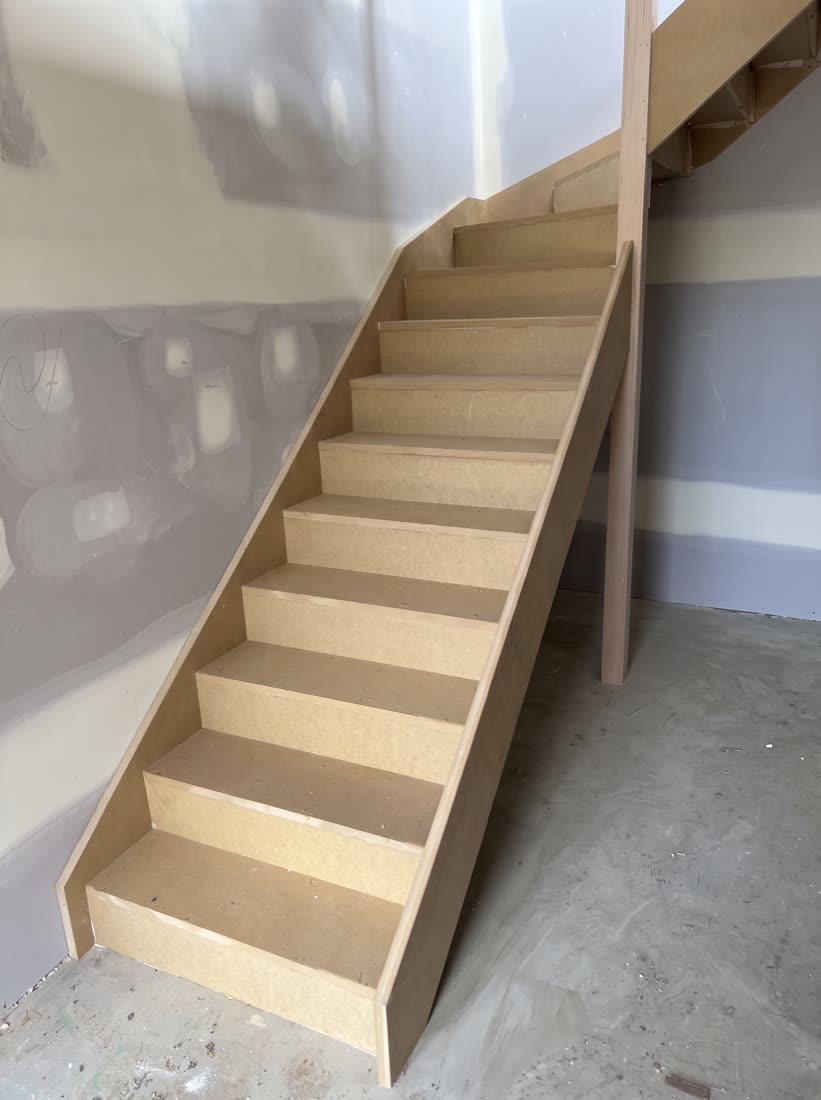 An MDF staircase newly installed, ready to be painted, carpeted or covered with engineered flooring